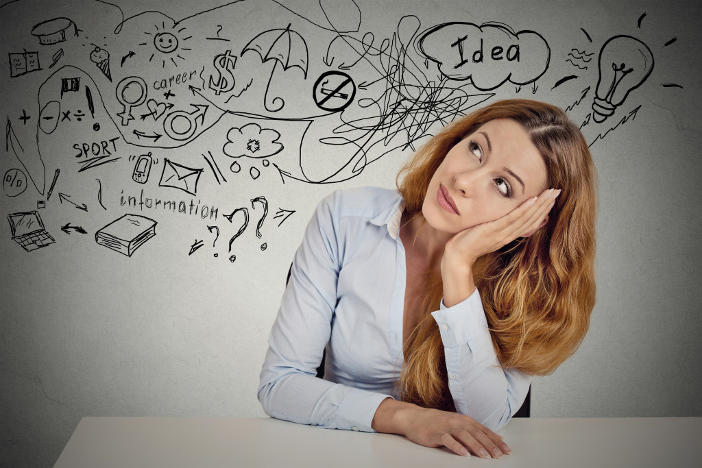 woman sitting at table has many ideas planning future