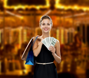 smiling woman in dress with shopping bags - image Wealth_Mainimage-300x263 on https://thedreamcatch.com