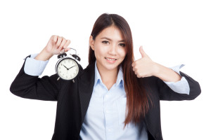 Young Asian businesswoman thumbs up with alarm clock - image right-timing_main-image-300x200 on https://thedreamcatch.com