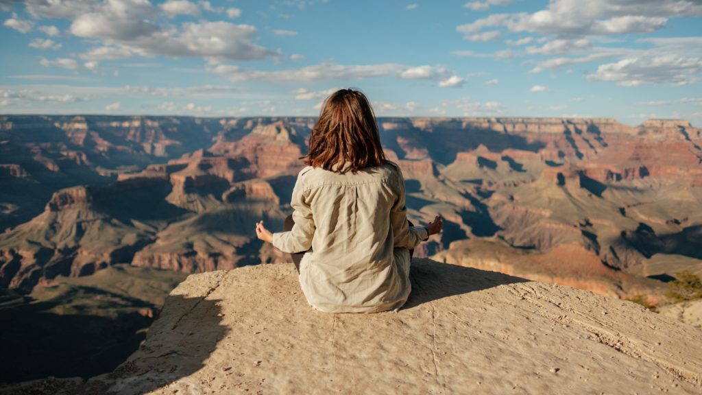 Can't Find Happiness Within Yourself (and in the now)? Here's Why. - image woman-meditate-1024x576 on https://thedreamcatch.com