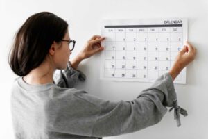 Woman checking the calendar - image  on https://thedreamcatch.com